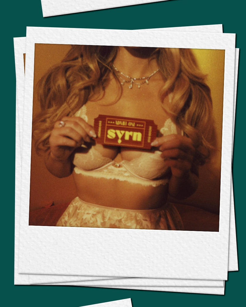 Woman with a ticket that says SYRN